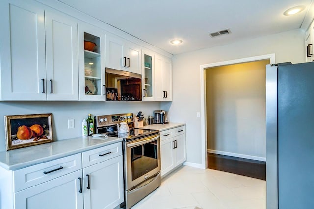 kitchen featuring visible vents, white cabinets, appliances with stainless steel finishes, and light countertops