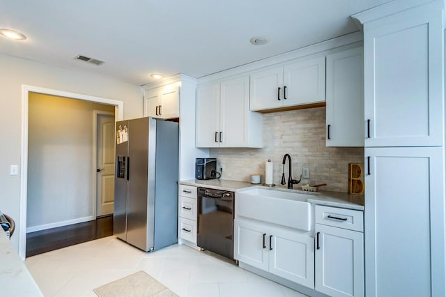 kitchen featuring black dishwasher, visible vents, stainless steel refrigerator with ice dispenser, backsplash, and white cabinetry