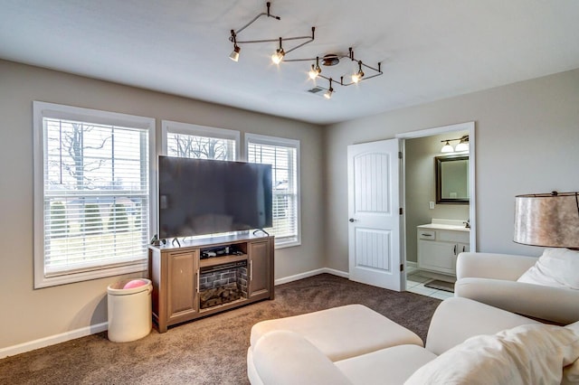 living room featuring carpet and baseboards