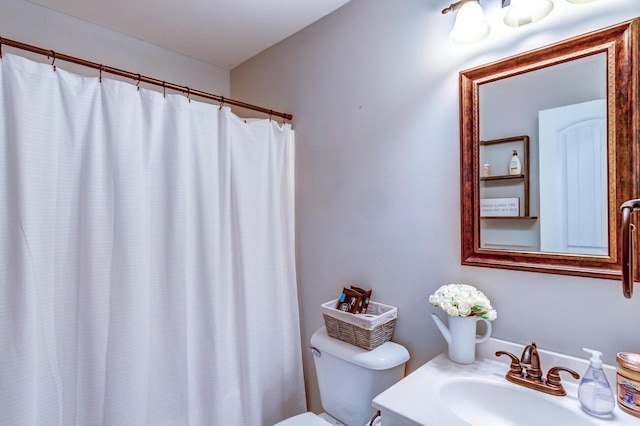bathroom featuring toilet, a shower with curtain, and vanity