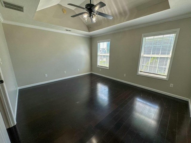 spare room featuring a raised ceiling, visible vents, dark wood-style floors, and baseboards