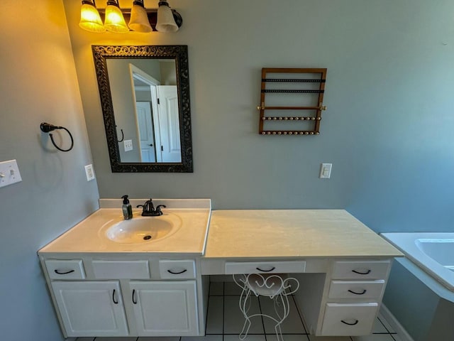 bathroom with tile patterned flooring, a tub, and vanity