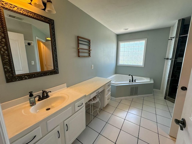 bathroom featuring tile patterned floors, a shower stall, a bath, vanity, and visible vents