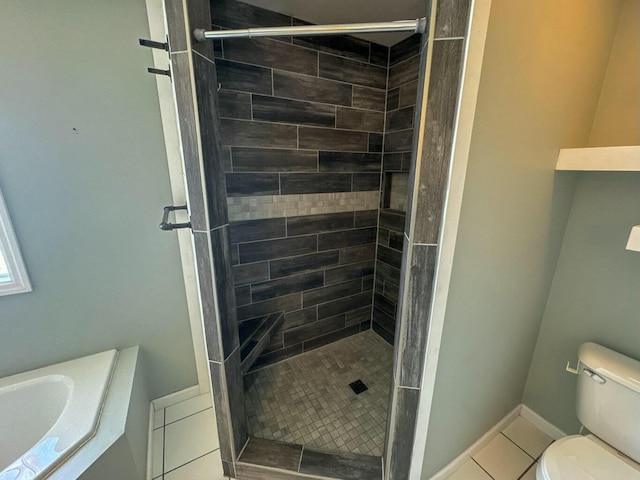 full bathroom with tile patterned floors, toilet, a shower stall, and baseboards