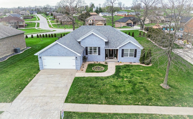 ranch-style home with a front yard, a residential view, driveway, and an attached garage