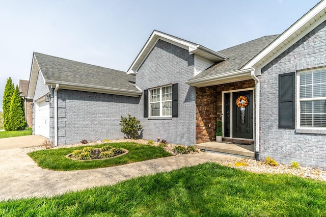 exterior space featuring stone siding, a shingled roof, a yard, brick siding, and a garage
