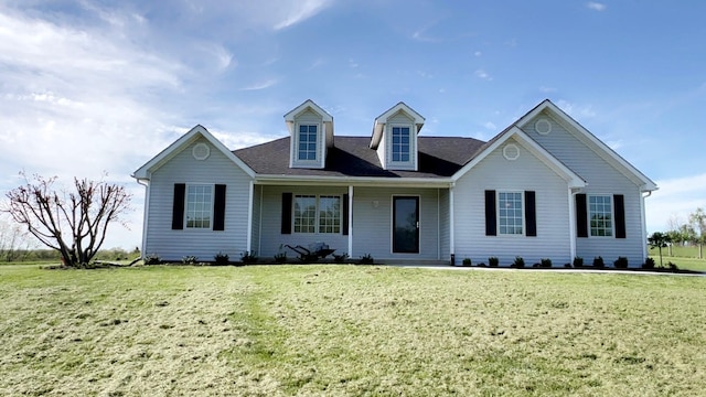 cape cod home featuring covered porch and a front yard