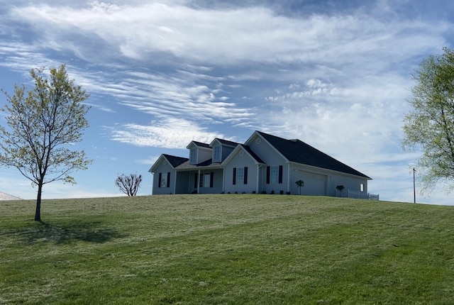 view of front of house featuring a garage and a front lawn
