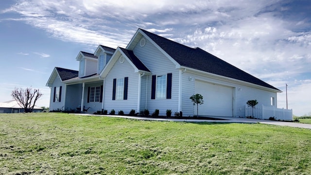 view of side of property with a lawn and a garage