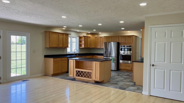 kitchen featuring visible vents, open shelves, dark countertops, light wood-type flooring, and stainless steel appliances