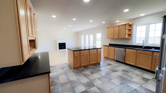 kitchen featuring stainless steel dishwasher, recessed lighting, and a sink