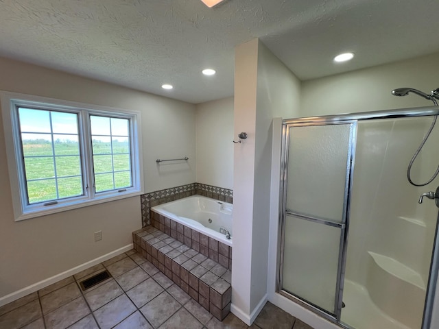 bathroom with visible vents, tile patterned flooring, a jetted tub, baseboards, and a shower stall