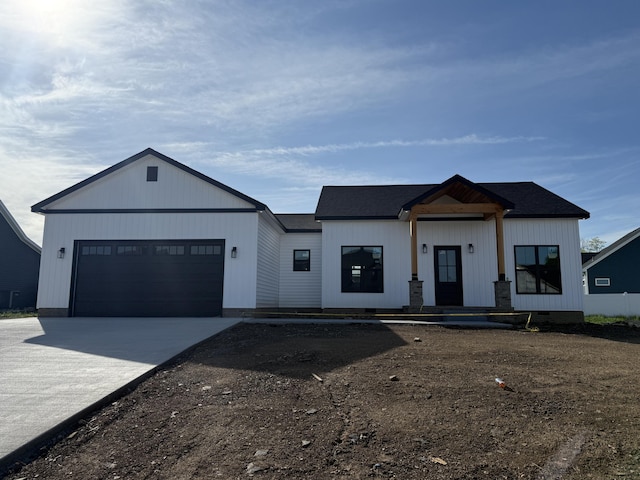 modern farmhouse style home with driveway and an attached garage