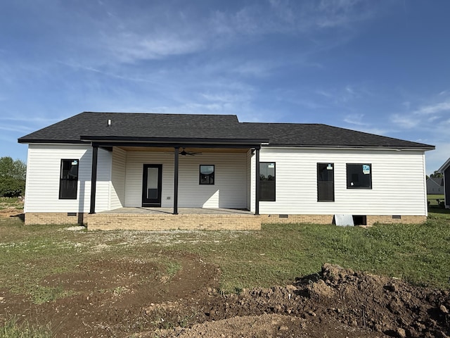 back of house featuring a lawn, crawl space, and a shingled roof