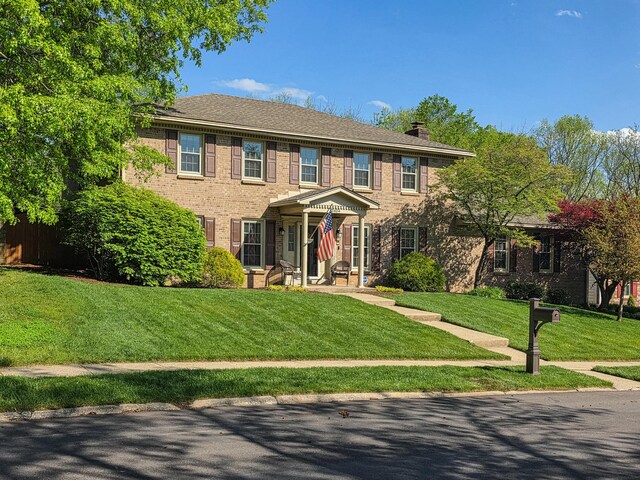 3404 Grasmere Dr, Lexington, KY 40503 - view of front facade featuring brick siding, a chimney, and a front yard
