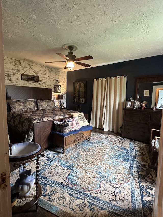 bedroom with ceiling fan and a textured ceiling