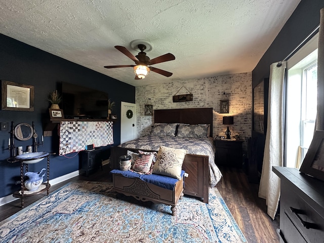 bedroom featuring baseboards, a textured ceiling, ceiling fan, and wood finished floors