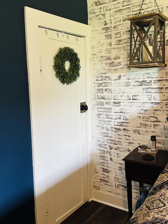 interior space with baseboards and dark wood-style floors