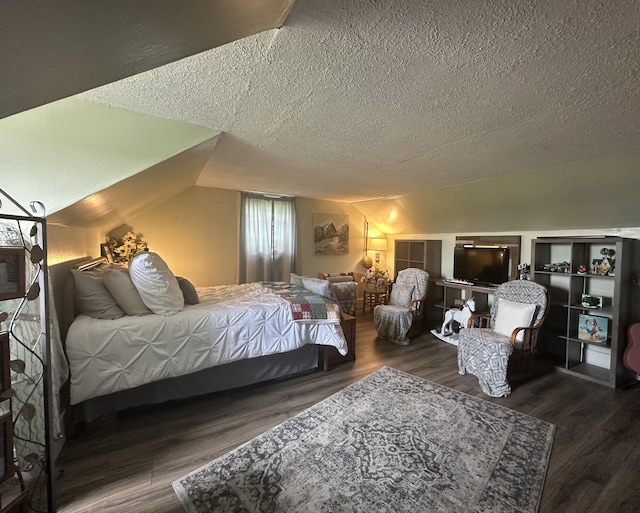bedroom with a textured ceiling and wood finished floors
