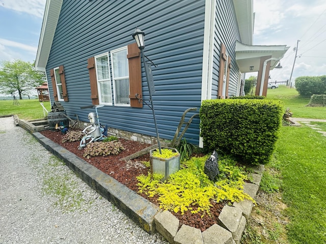 view of property exterior with a lawn