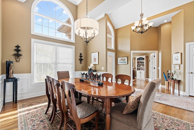 204 Helmsley Ln, Versailles, KY 40383 - dining room featuring a chandelier, a towering ceiling, wood finished floors, and a wainscoted wall