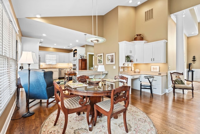 204 Helmsley Ln, Versailles, KY 40383 - dining space featuring wood finished floors, high vaulted ceiling, and decorative columns