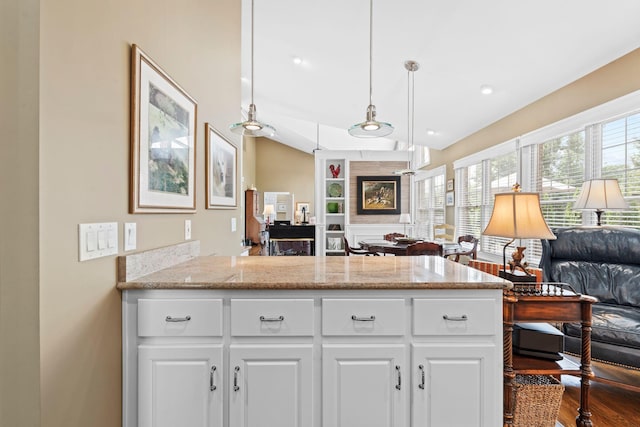 204 Helmsley Ln, Versailles, KY 40383 - kitchen featuring open floor plan, a peninsula, white cabinetry, dark wood-type flooring, and light stone counters