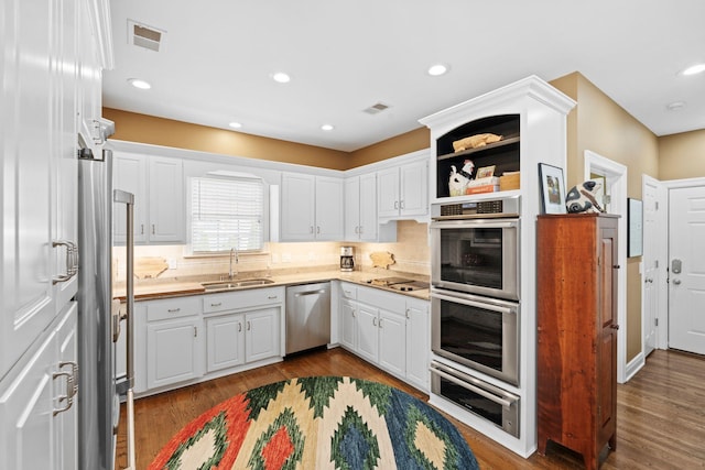 204 Helmsley Ln, Versailles, KY 40383 - kitchen with appliances with stainless steel finishes, a sink, a warming drawer, white cabinetry, and light countertops