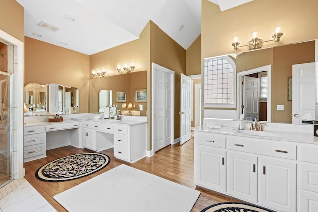 204 Helmsley Ln, Versailles, KY 40383 - full bath featuring two vanities, a shower stall, wood finished floors, and high vaulted ceiling