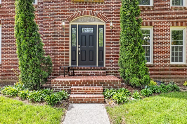 doorway to property featuring brick siding