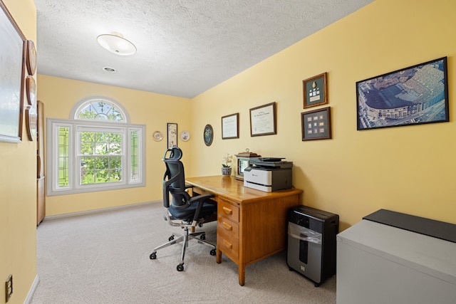 office space featuring baseboards, a textured ceiling, and carpet