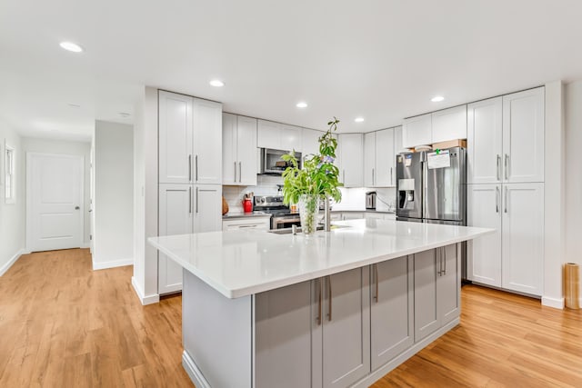 1144 Crenshaw Ln, Nicholasville, KY 40356 - kitchen featuring light wood-style flooring, a sink, stainless steel appliances, light countertops, and tasteful backsplash