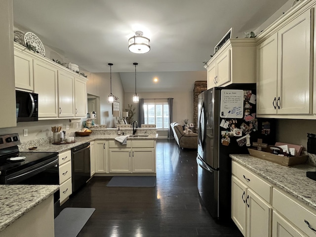 kitchen featuring hanging light fixtures, a sink, black appliances, a peninsula, and open floor plan