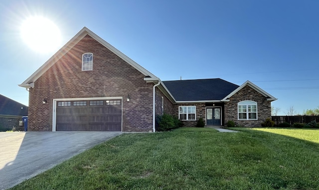ranch-style house featuring a front lawn, stone siding, brick siding, concrete driveway, and an attached garage