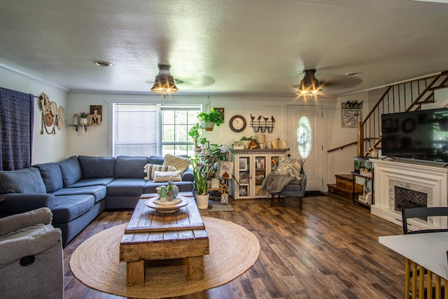 living room with crown molding, stairs, ceiling fan, and wood finished floors