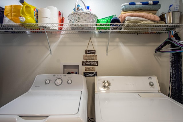 clothes washing area featuring laundry area and washer and clothes dryer