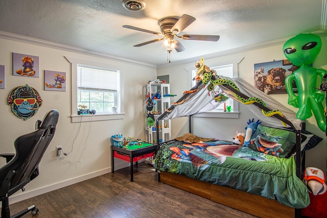 bedroom with crown molding, a textured ceiling, wood finished floors, and visible vents