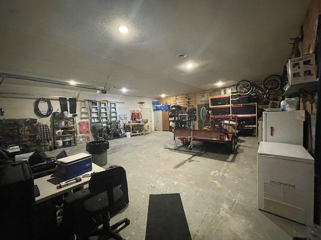 garage featuring a workshop area and fridge