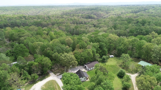 drone / aerial view with a wooded view