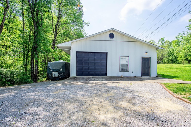 detached garage with gravel driveway