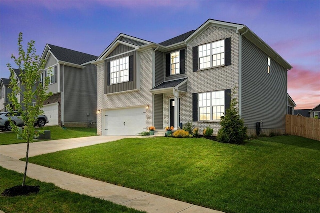 traditional home featuring fence, an attached garage, brick siding, a yard, and driveway