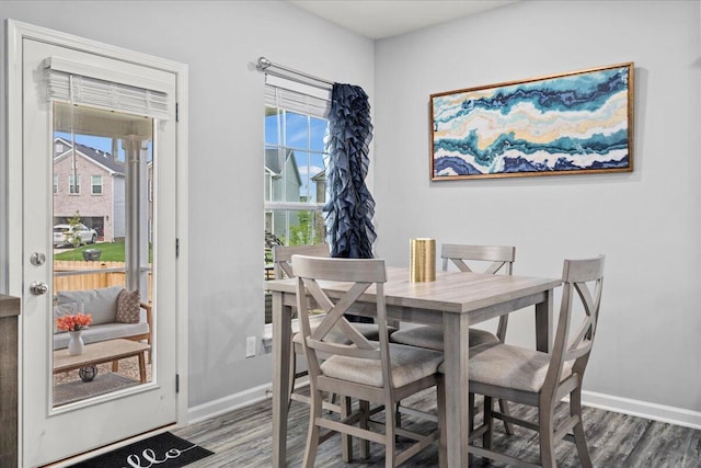 dining area featuring baseboards and wood finished floors