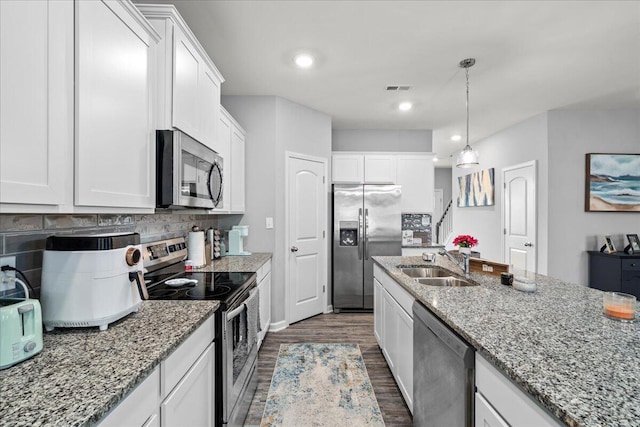 kitchen with visible vents, appliances with stainless steel finishes, a sink, white cabinetry, and dark wood-type flooring