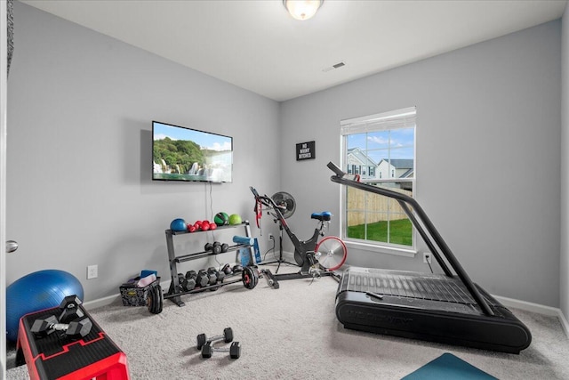workout area featuring baseboards, carpet, and visible vents