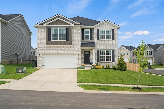 view of front of home with an attached garage, concrete driveway, a front yard, and brick siding
