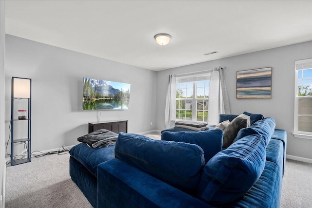 living room with carpet floors, baseboards, and visible vents