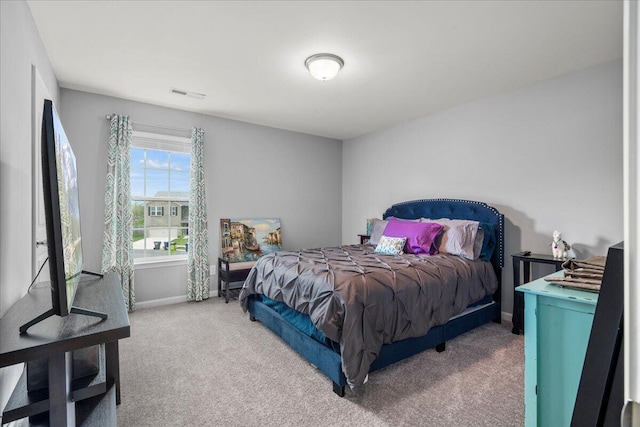 bedroom with light colored carpet, baseboards, and visible vents