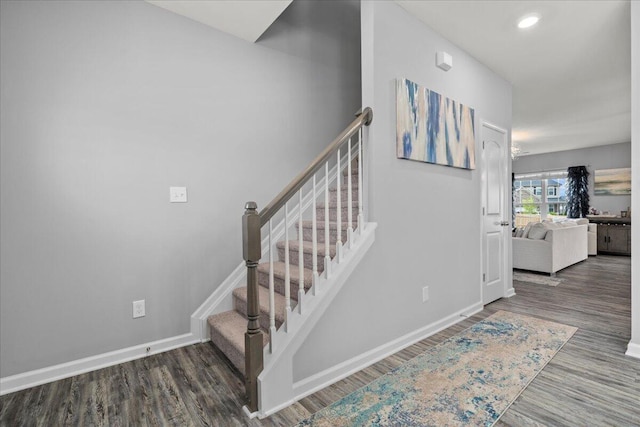 stairway with baseboards, recessed lighting, and wood finished floors