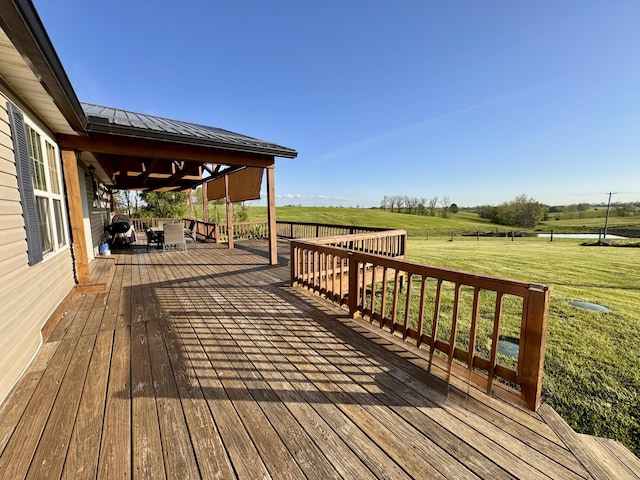 deck featuring a yard and a rural view