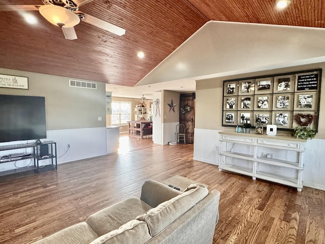 living area featuring a wainscoted wall, ceiling fan, wood ceiling, and visible vents